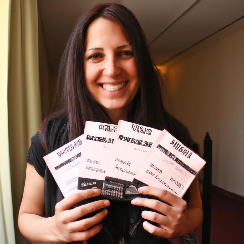 Person holding concert tickets, smiling